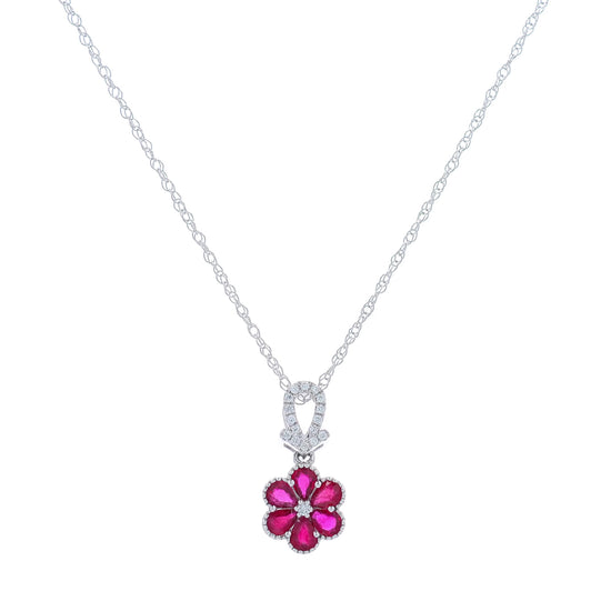 White gold flower design ruby and diamond pendant necklace on a white background