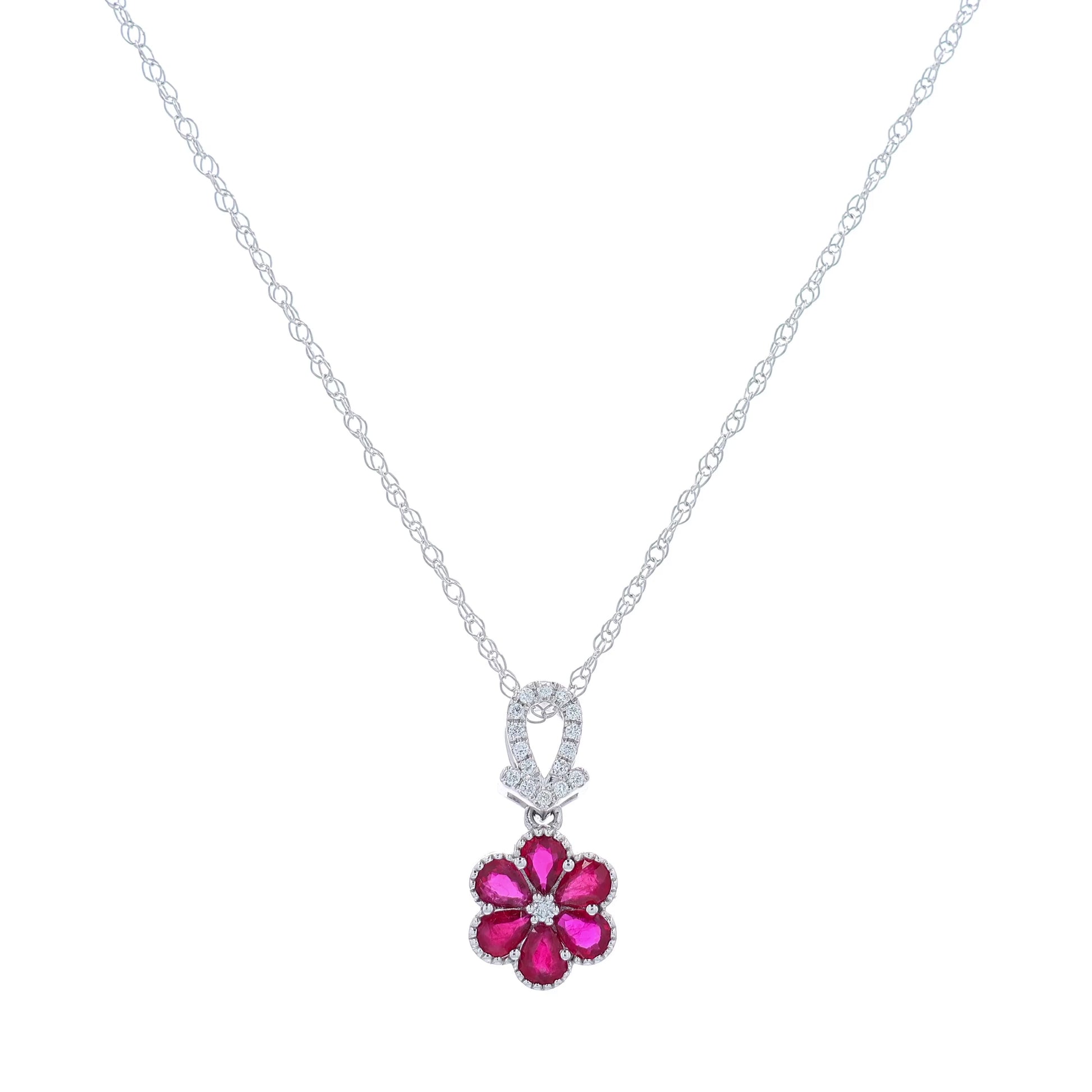 White gold flower design ruby and diamond pendant necklace on a white background