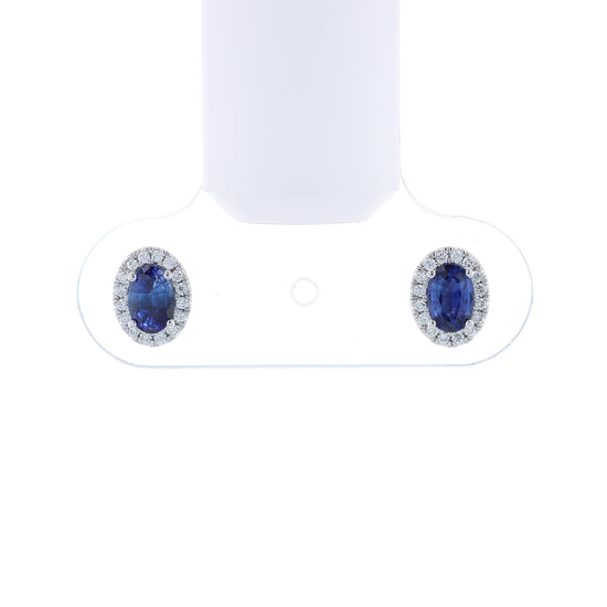 Pair of sapphire and diamond halo stud earrings on a white background