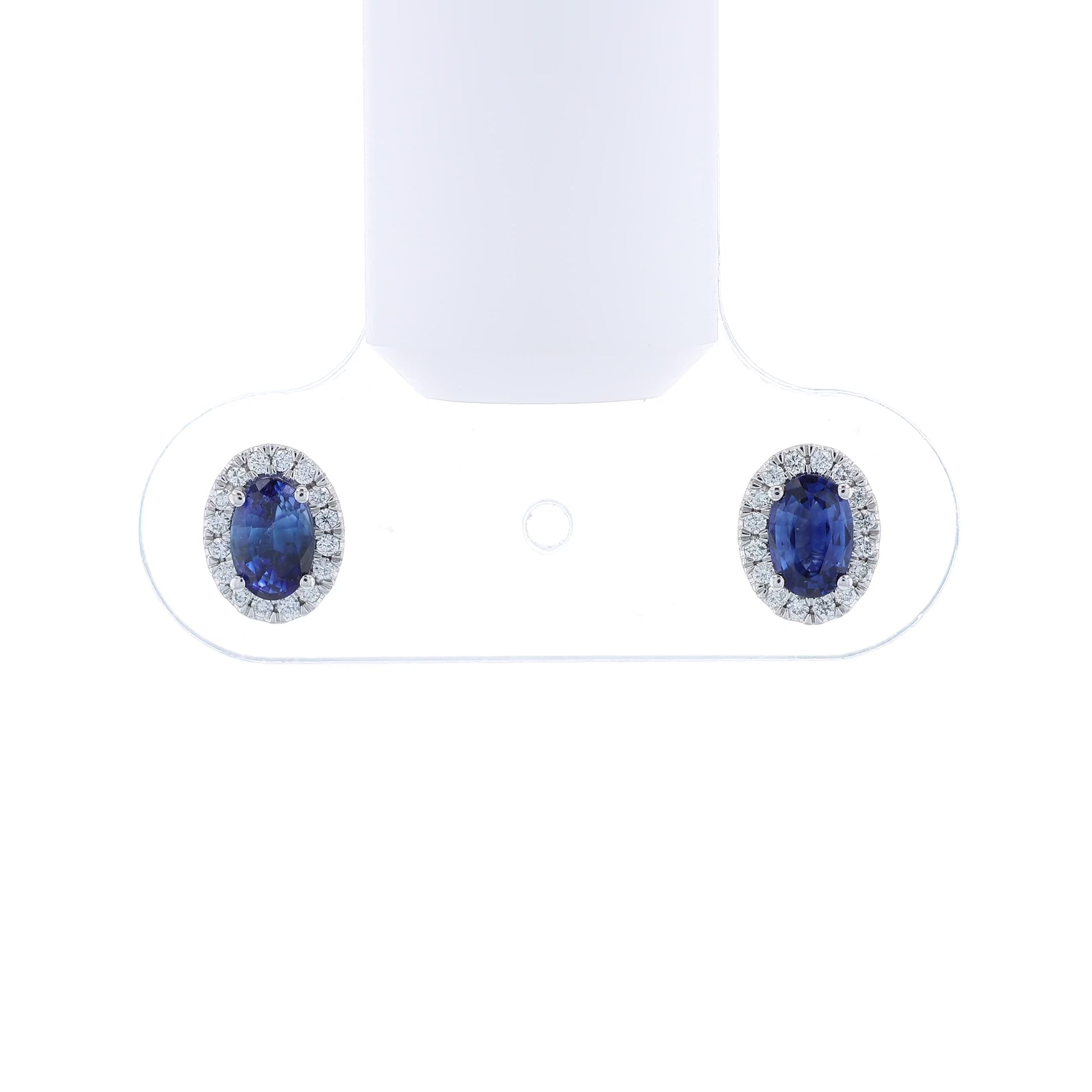 Pair of sapphire and diamond halo stud earrings on a white background