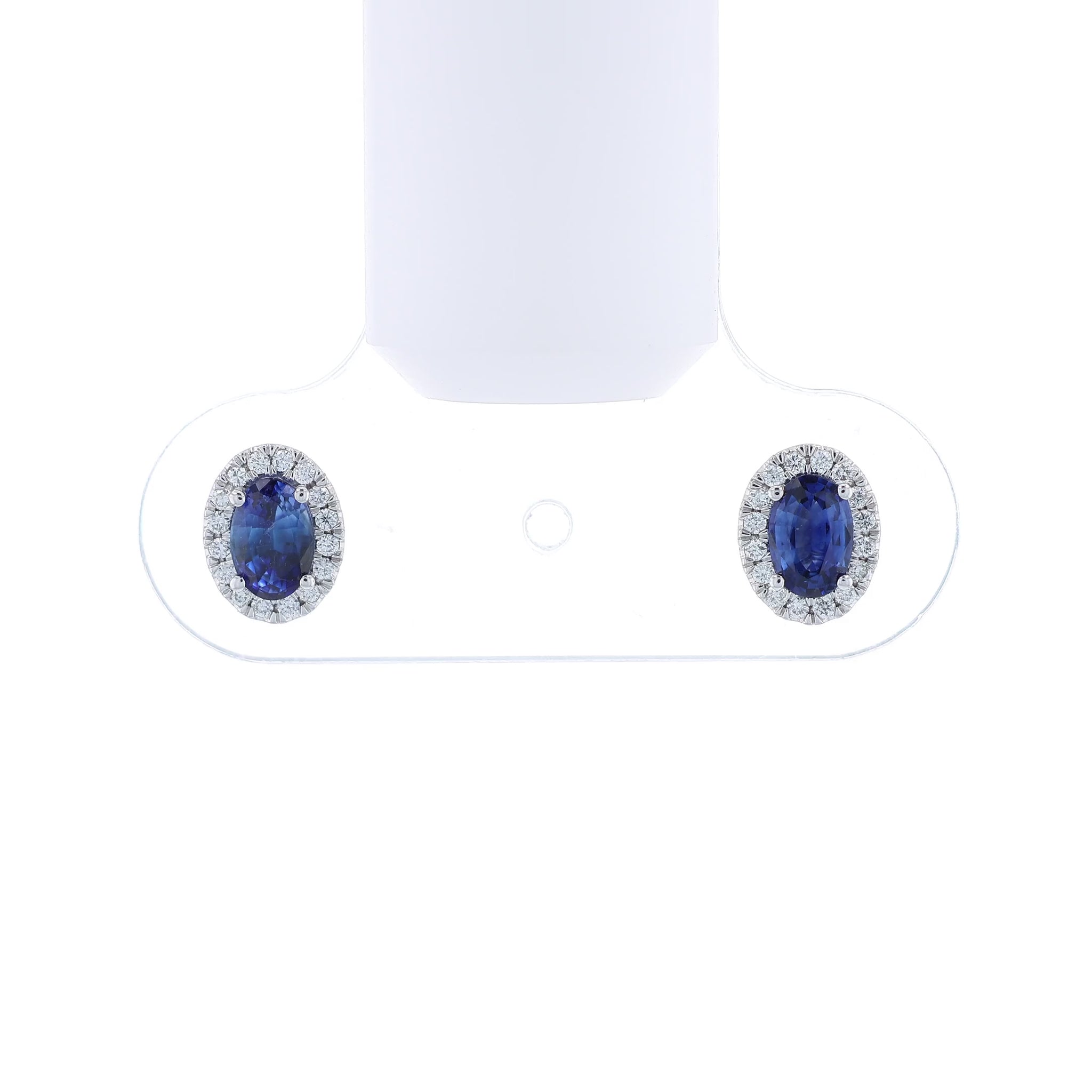 Pair of sapphire and diamond halo stud earrings on a white background