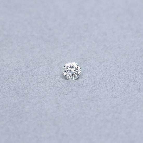 Round .70 carat GIA certified diamond graded DSI1 on a grey background