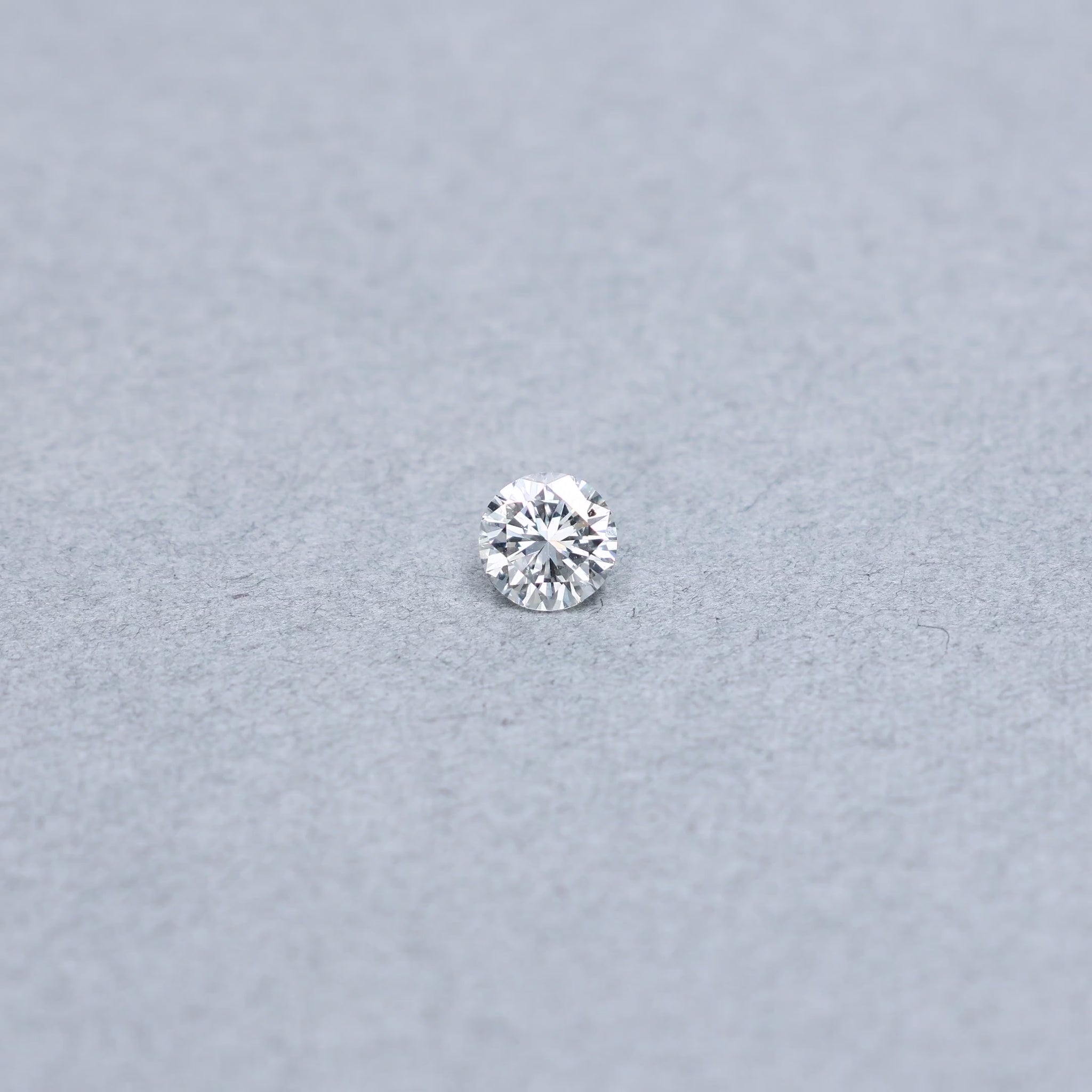 Round .70 carat GIA certified diamond graded DSI1 on a grey background