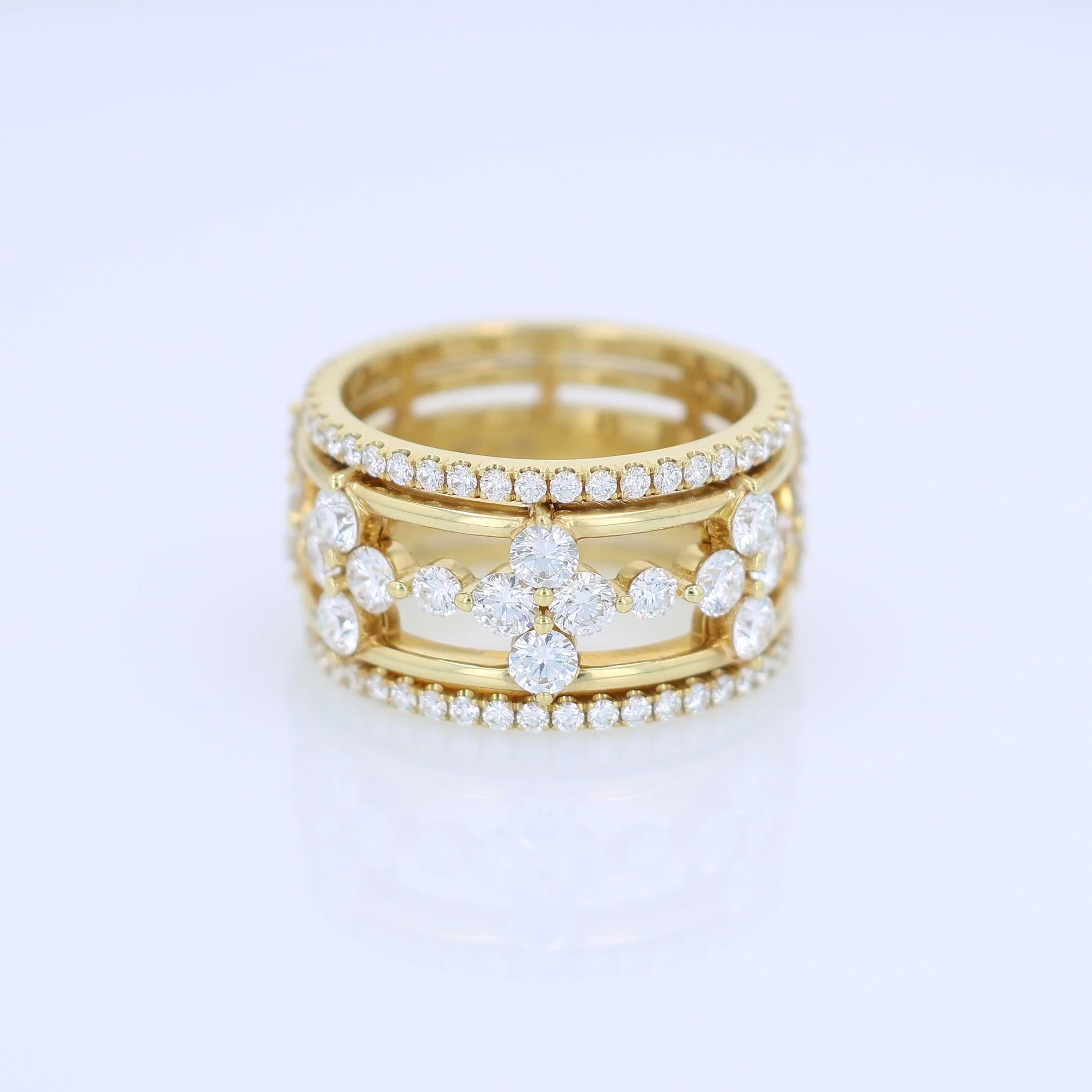 Yellow gold ring with diamond accents on a white background