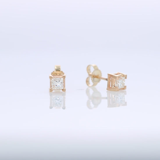 Yellow gold princess cut diamond stud earrings totaling 0.48 carats on a white background