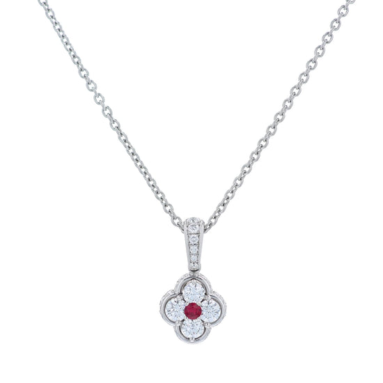 Platinum diamond and ruby pendant on a chain against a white background