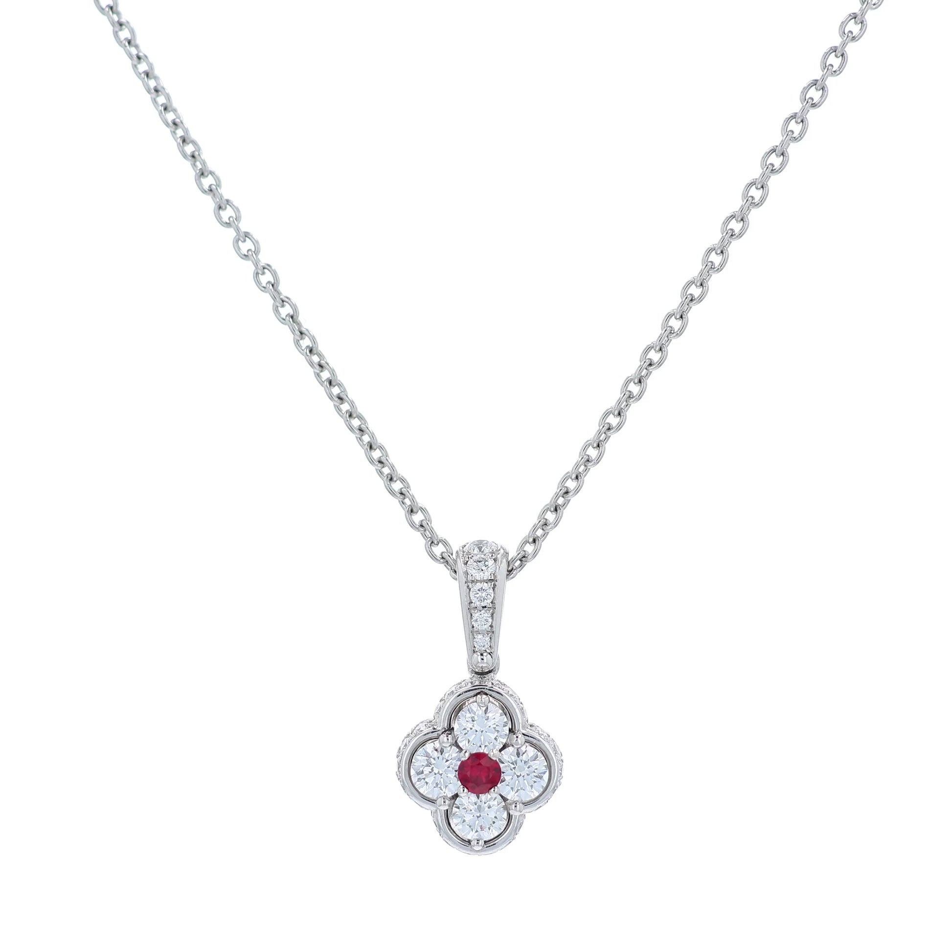 Platinum diamond and ruby pendant on a chain against a white background
