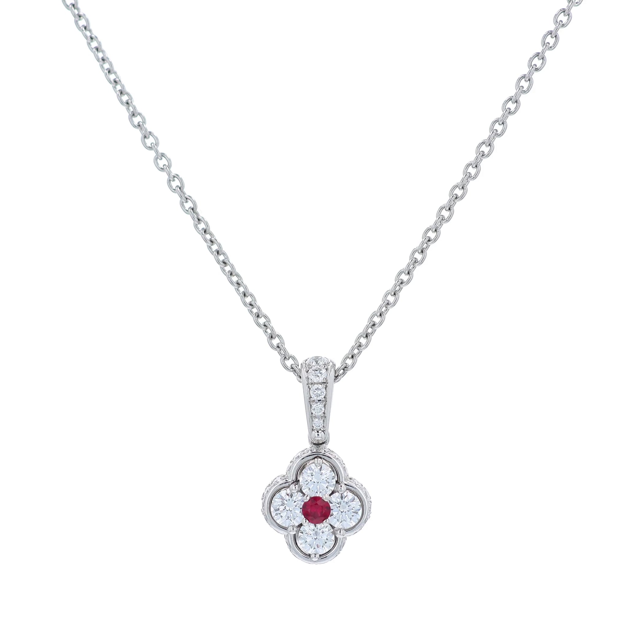 Platinum diamond and ruby pendant on a chain against a white background