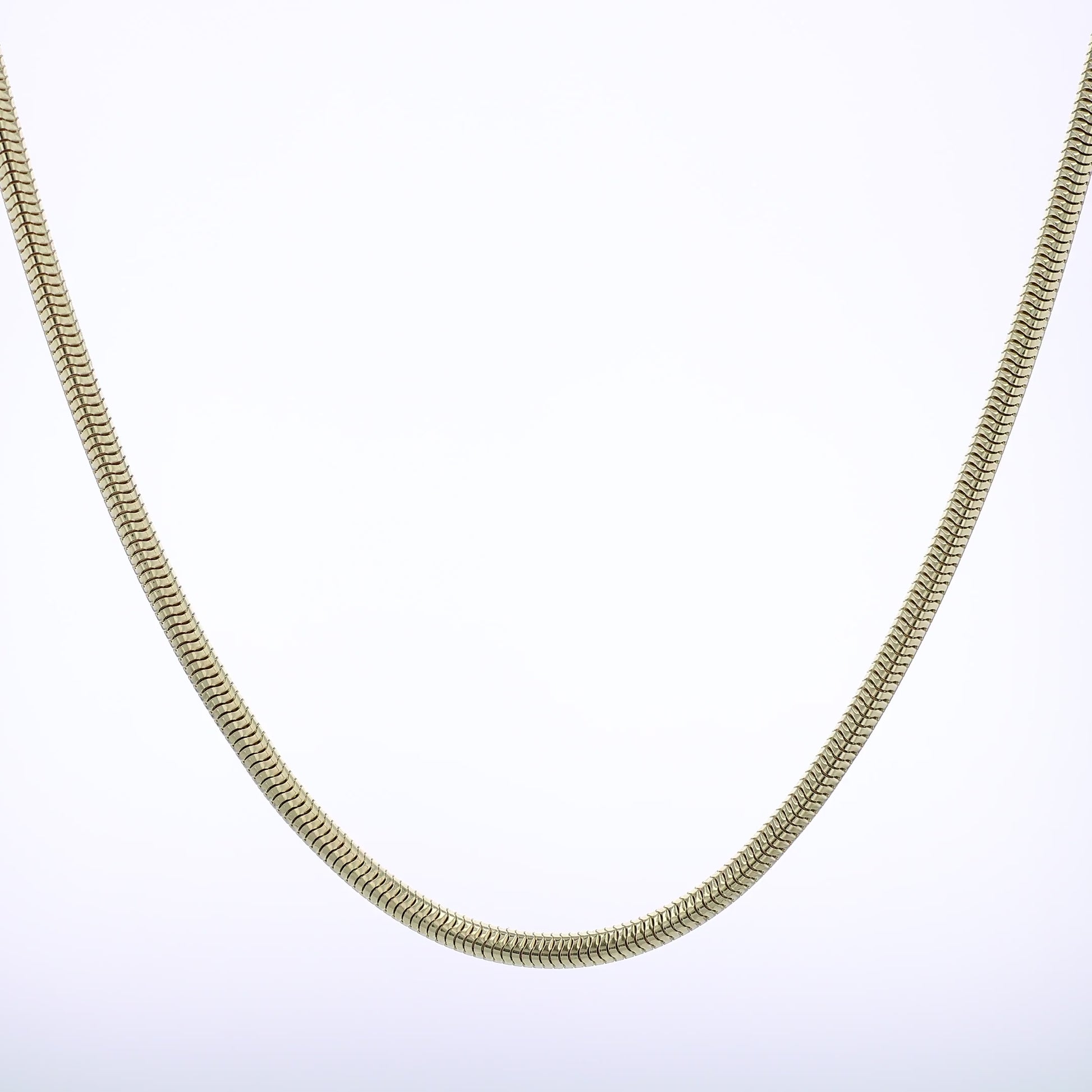 Polished Yellow gold tubogas chain necklace on a white background