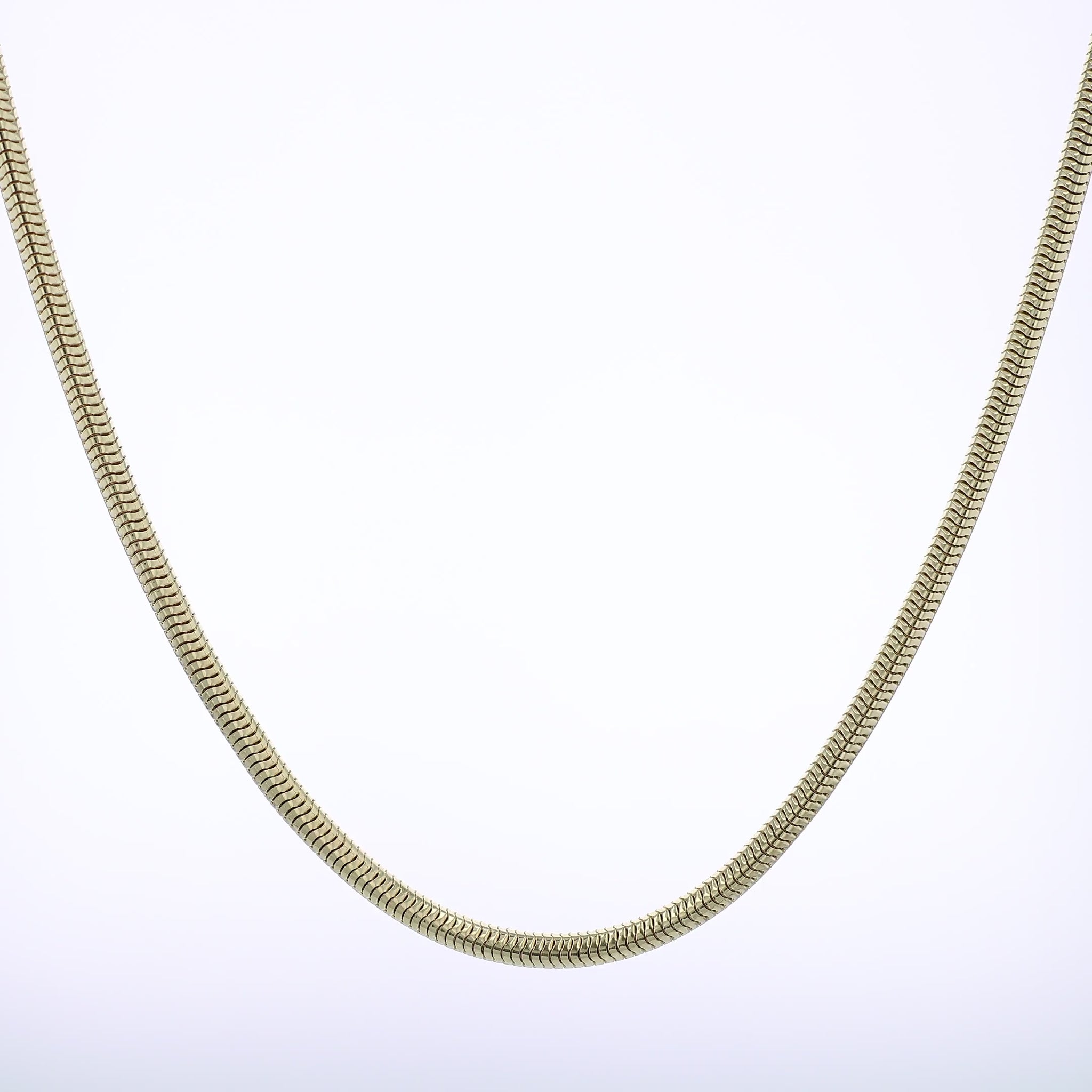 Polished Yellow gold tubogas chain necklace on a white background
