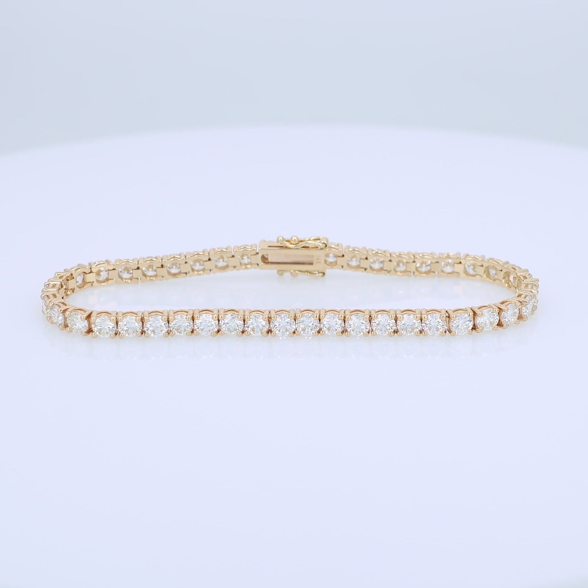 Yellow gold 9.00 carat diamond tennis bracelet on a white background