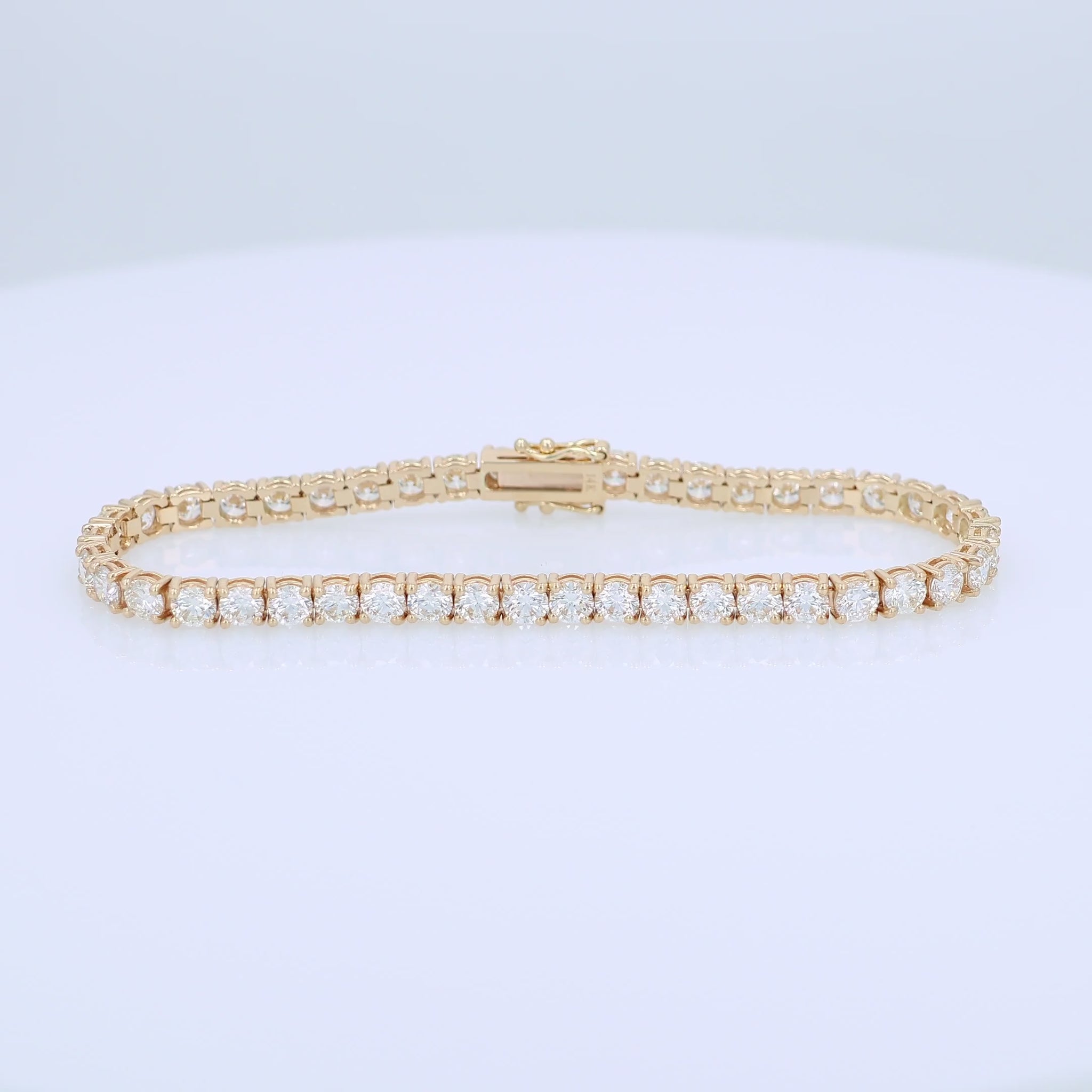 Yellow gold 9.00 carat diamond tennis bracelet on a white background