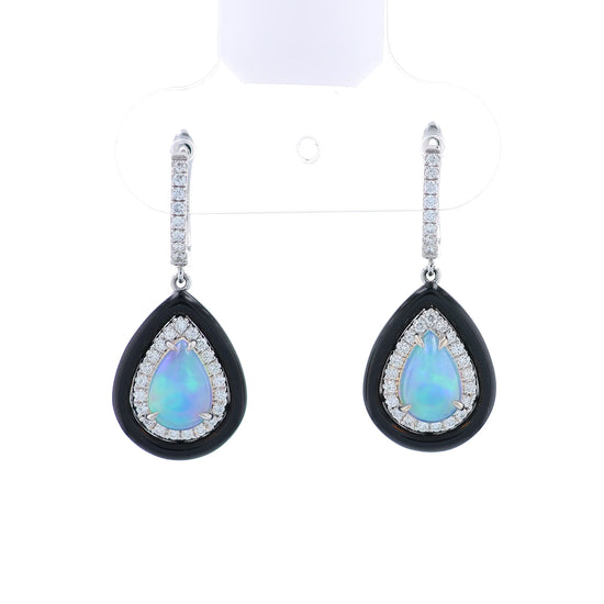 Pair of white gold black framed earrings with pear shaped opals and surrounding diamond halos on a white background