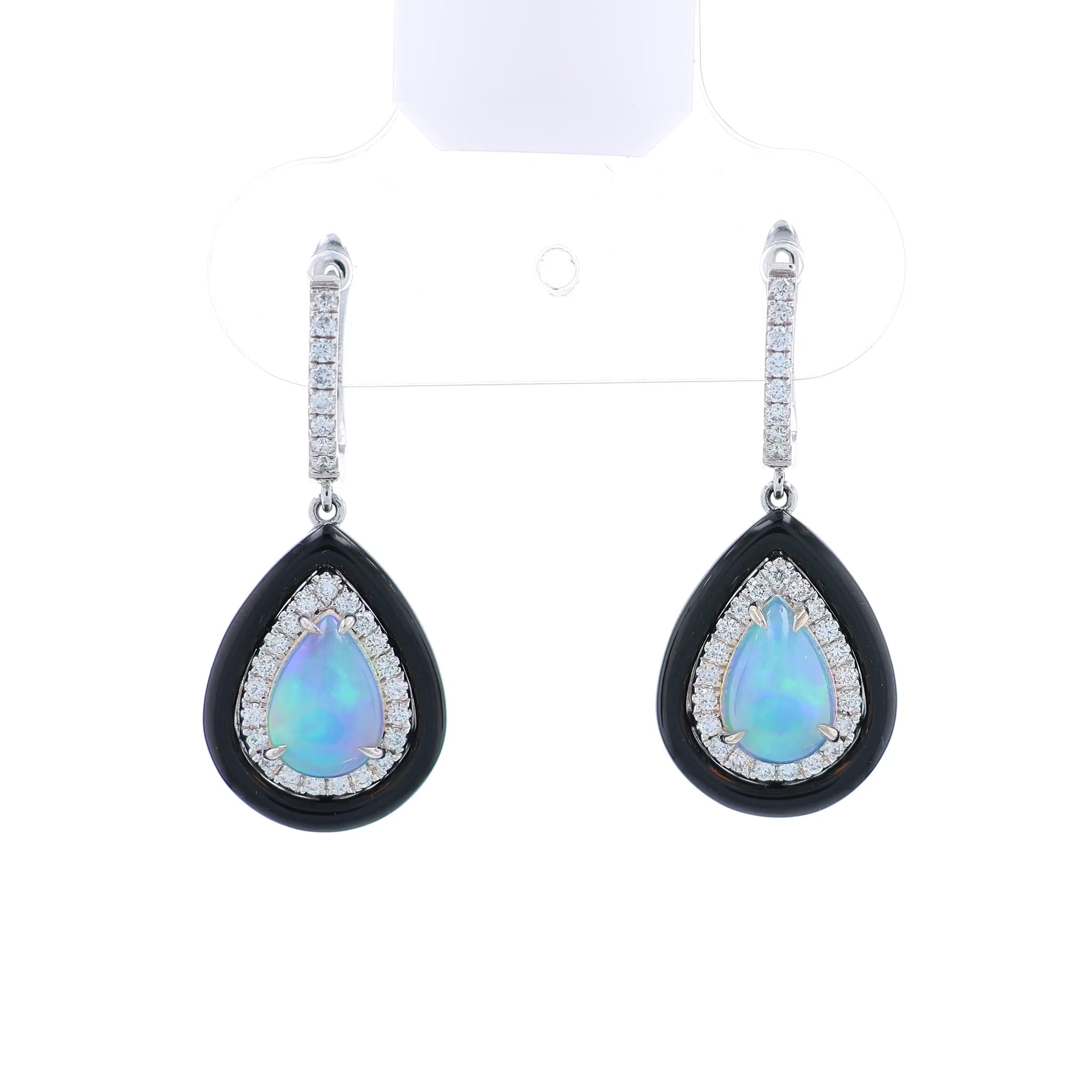 Pair of white gold black framed earrings with pear shaped opals and surrounding diamond halos on a white background