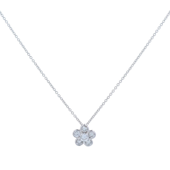 White gold flower shape diamond pendant necklace on a white background