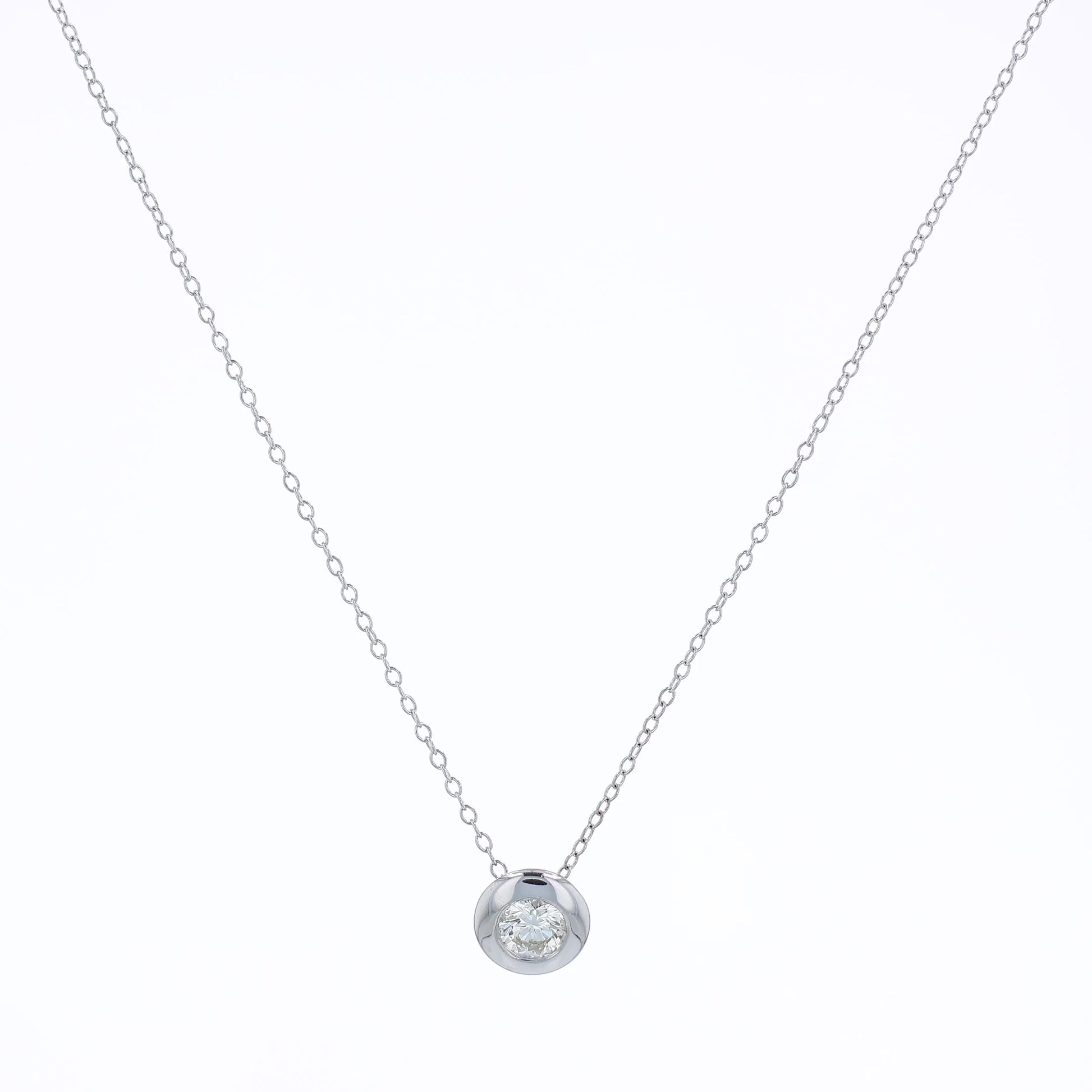 White gold bezel-set diamond pendant necklace on a white background
