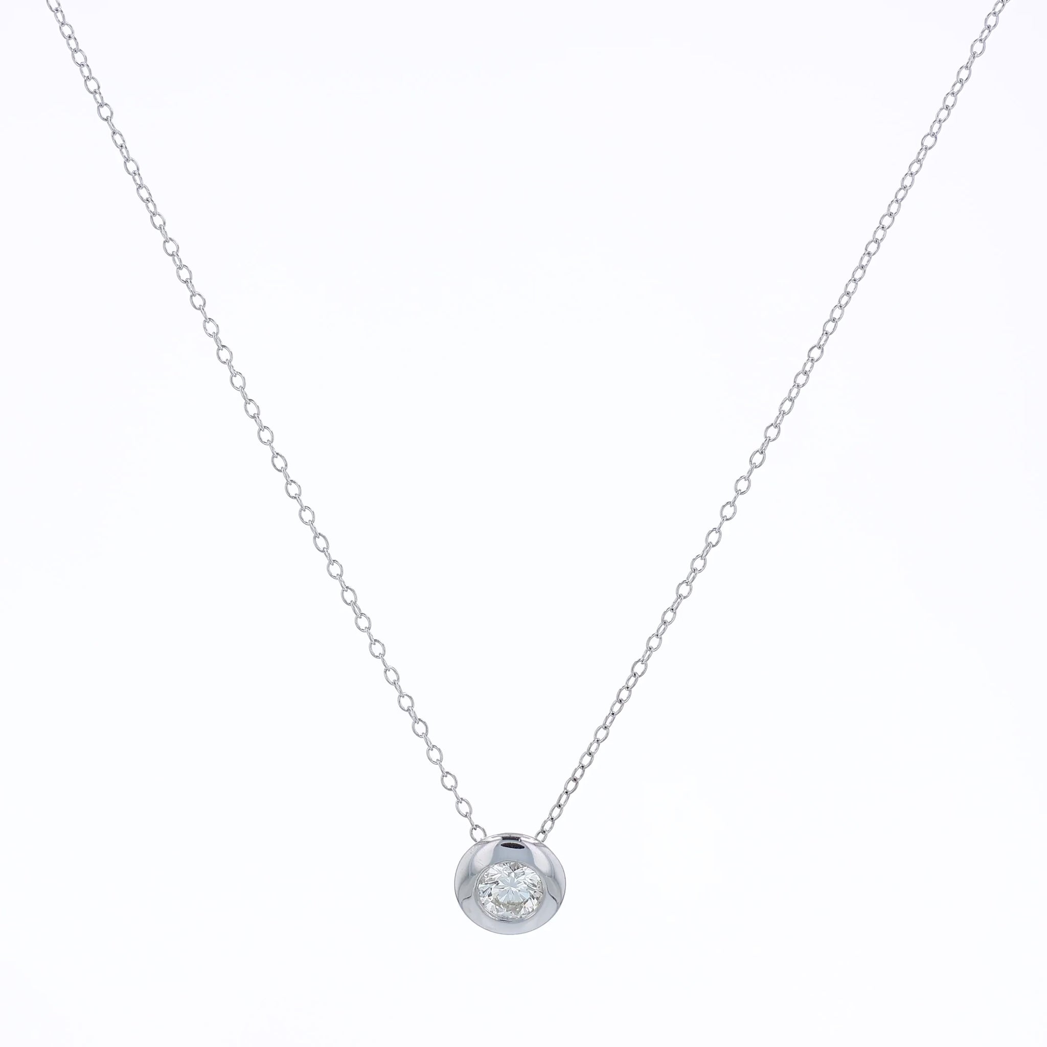 White gold bezel-set diamond pendant necklace on a white background