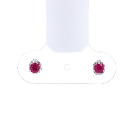White gold round ruby martini stud earrings on a white background