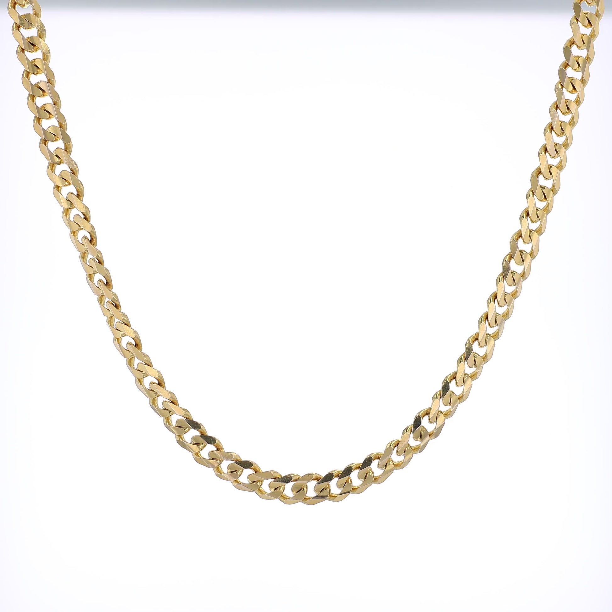 360 degree video of a yellow Gold curb link chain necklace on a white background