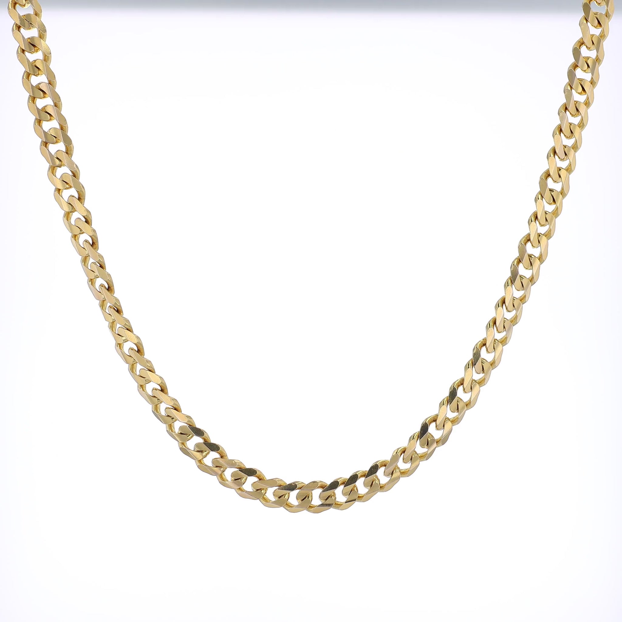 360 degree video of a yellow Gold curb link chain necklace on a white background