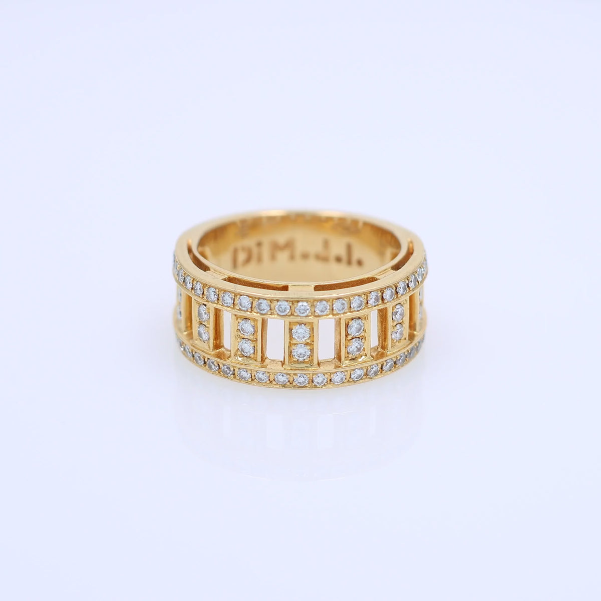 Yellow gold DiModolo branded fence link design diamond wedding band on a white background