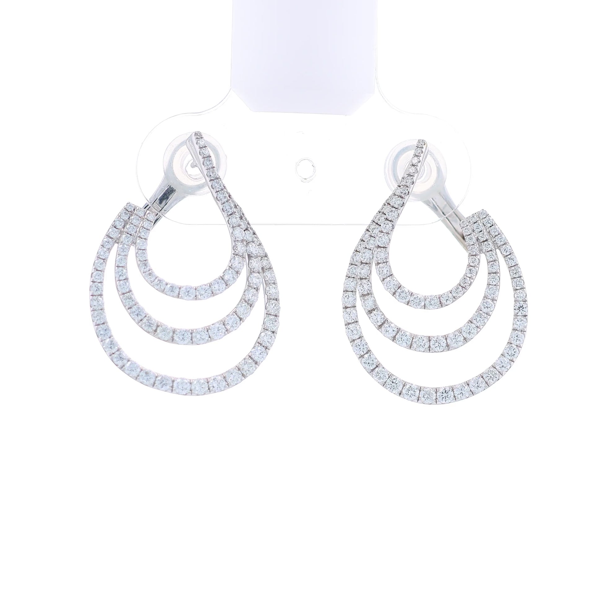 White gold 3 row diamond earrings on a white background