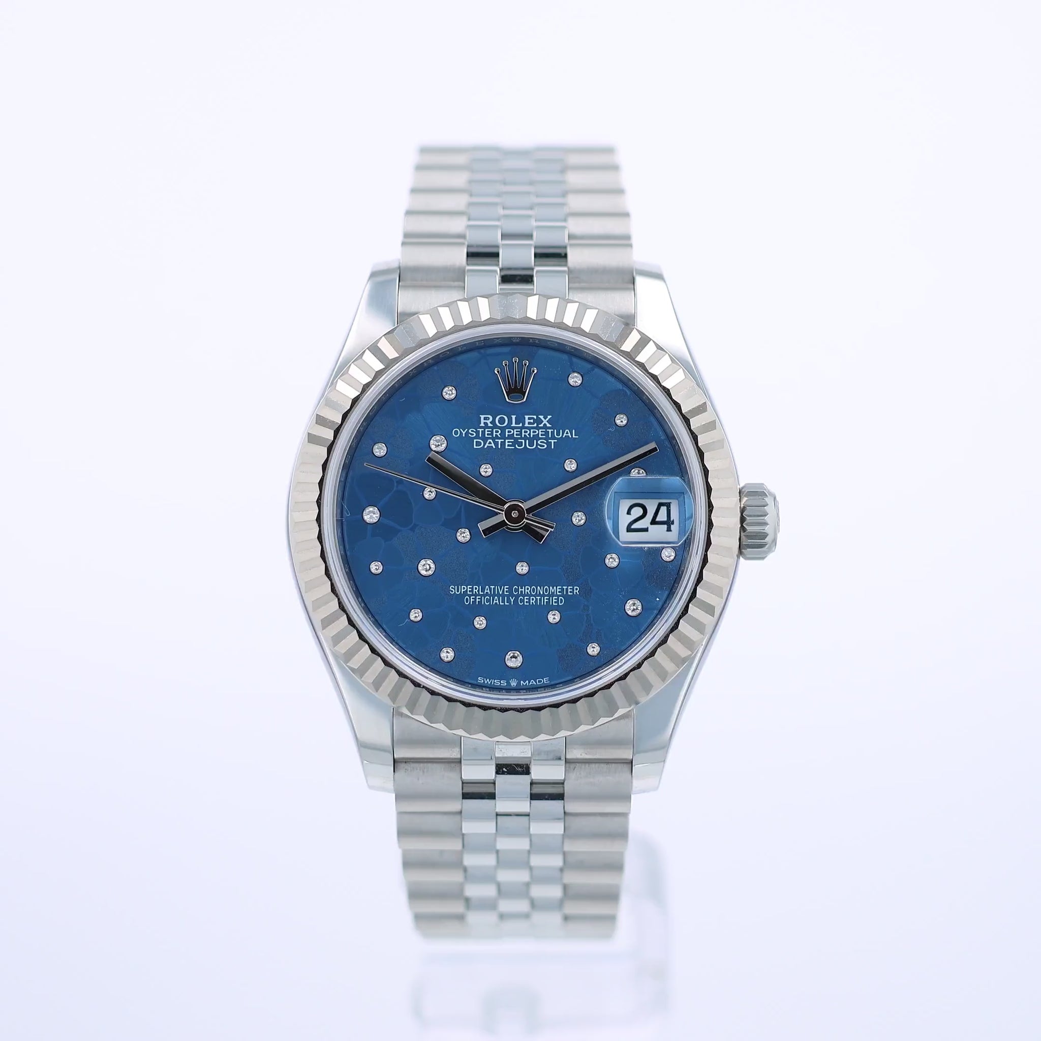 360 degree video of a steel Rolex watch with blue floral diamond dial on a white background
