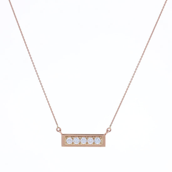Rose gold horizontal single row diamond bar pendant necklace on a white background