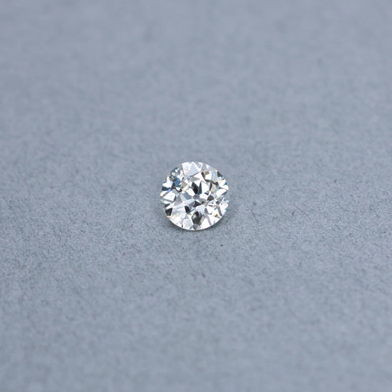 Old european 1.67 carat diamond graded KI1 on a grey background