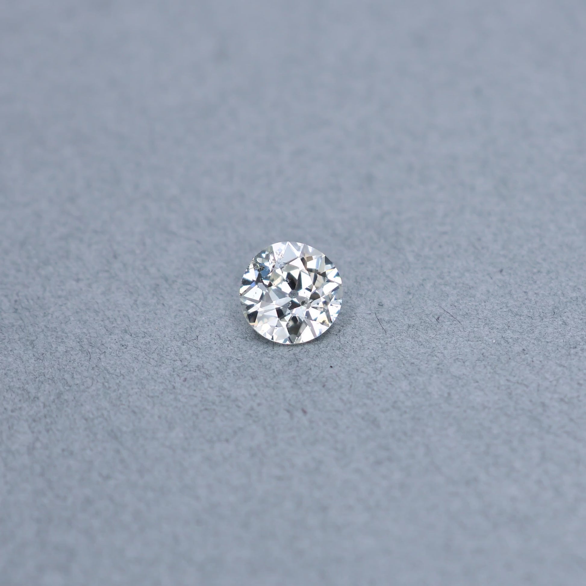Old european 1.67 carat diamond graded KI1 on a grey background