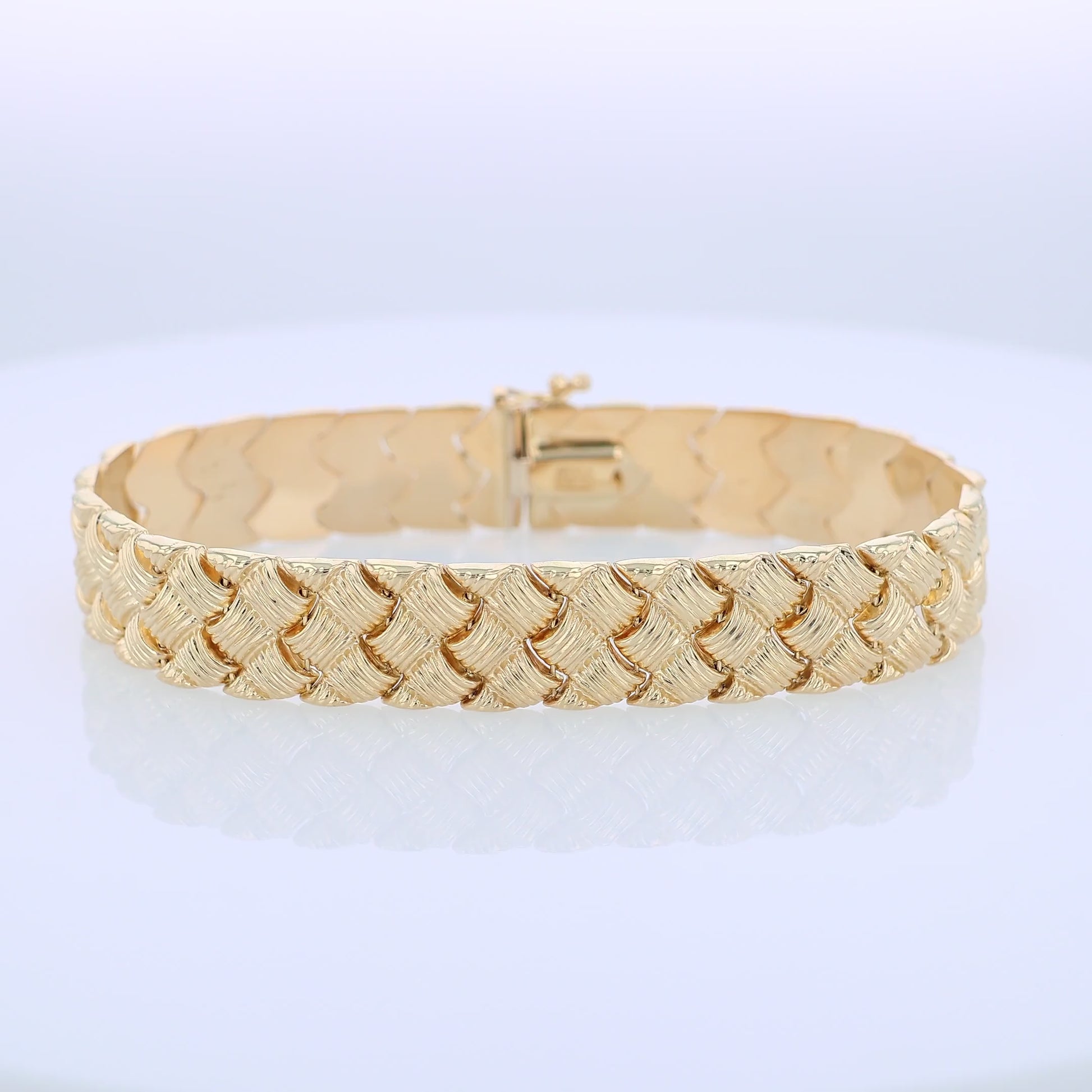 360 degree video of a textured yellow gold basket weave link bracelet on a white background