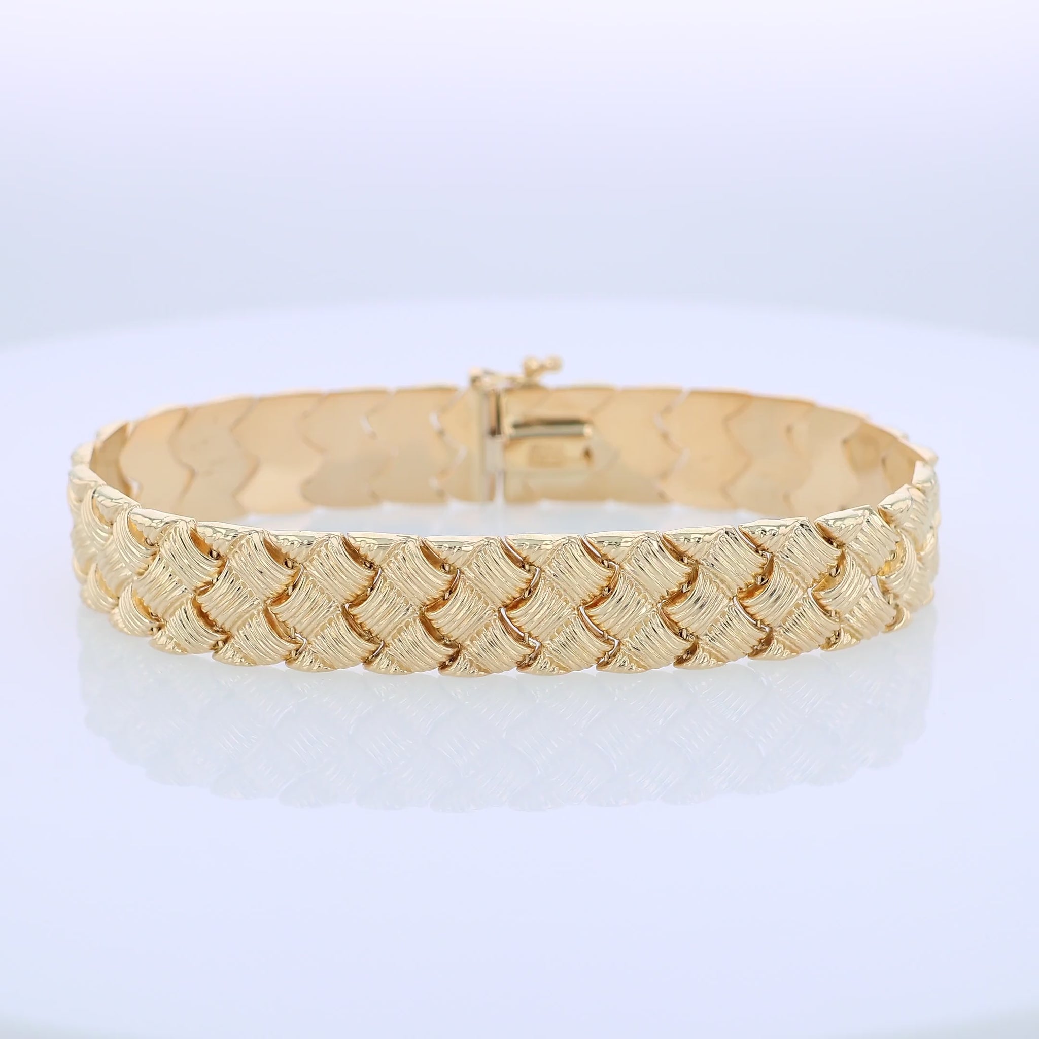 360 degree video of a textured yellow gold basket weave link bracelet on a white background