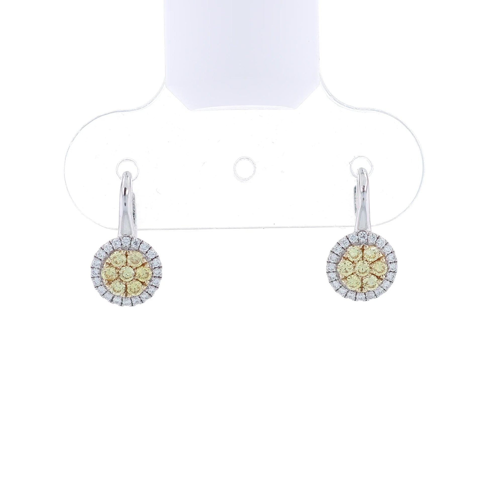 Pair of white gold yellow and white diamond cluster halo earrings on a white background