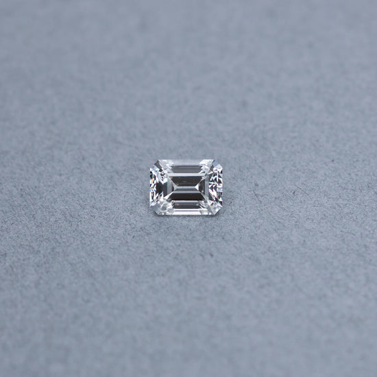 Emerald cut 2.02 carat GIA certified diamond graded EVS2 on a grey background