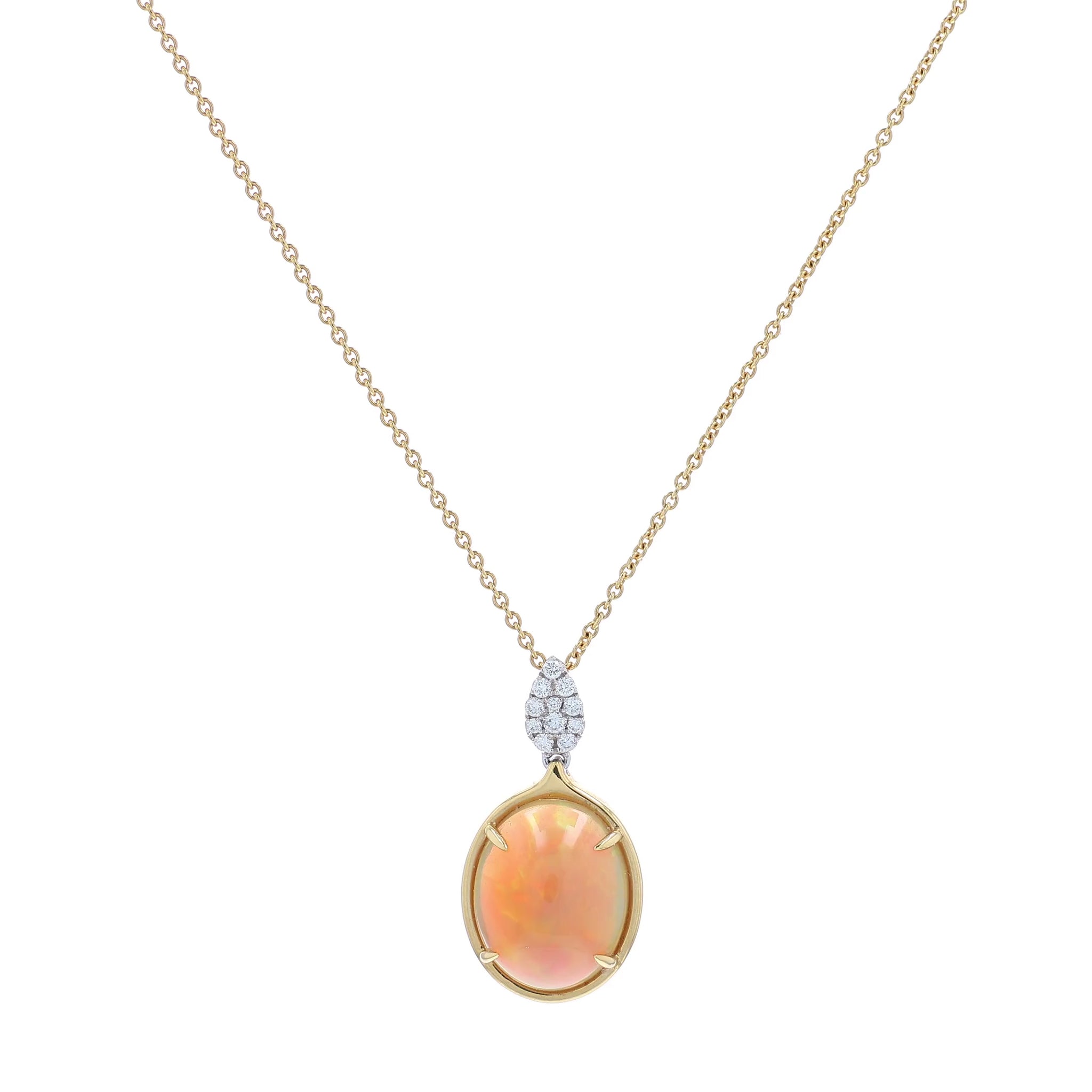 Yellow gold oval cabochon opal and diamond pendant necklace on a white background
