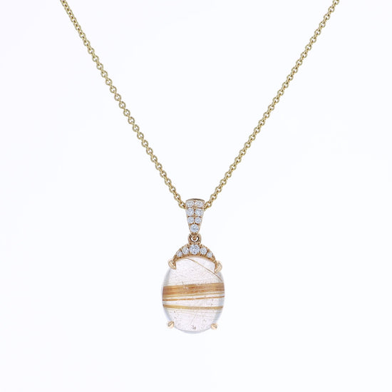 Yellow gold oval rutilated quartz and diamond pendant necklace on a white background