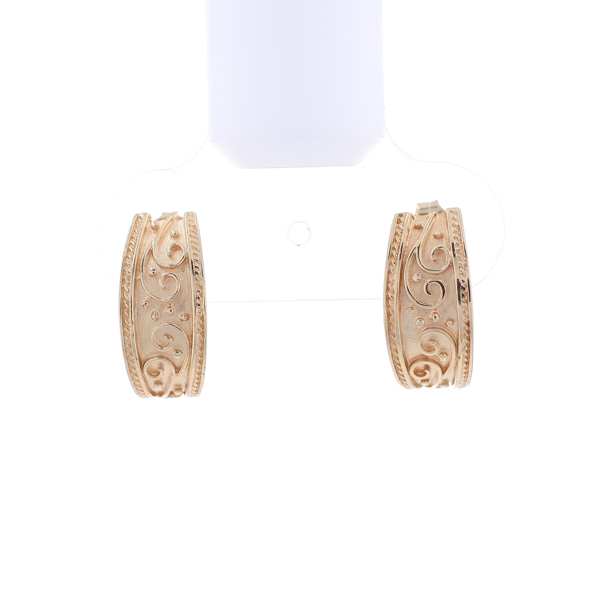 Yellow gold hoop earrings with an intricate scroll center design and a rope style border on a white background
