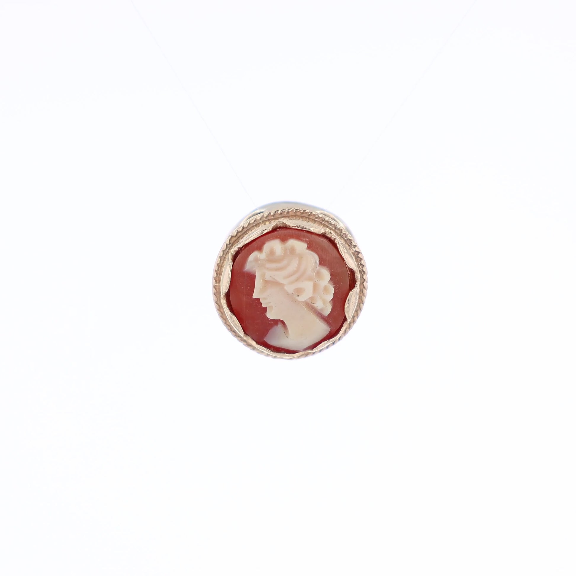 Yellow gold carved cameo slide pendant of a woman facing left on a white background