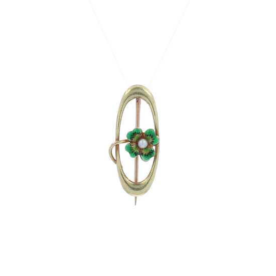 A video of a yellow gold open oval pin with a green enamel four leaf clover and a seed pearl on a white background