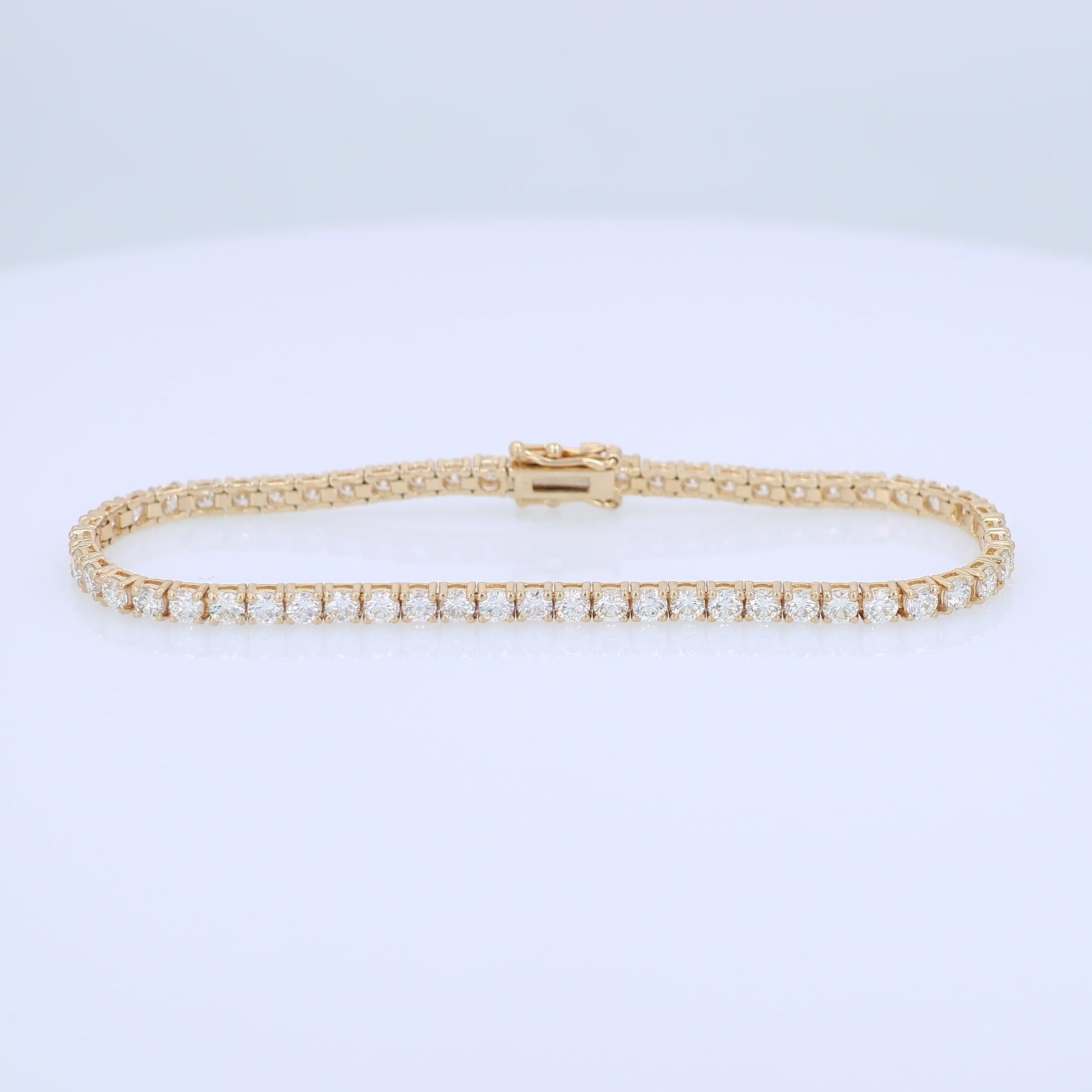 Yellow gold 5.03 carat diamond tennis bracelet on a white background