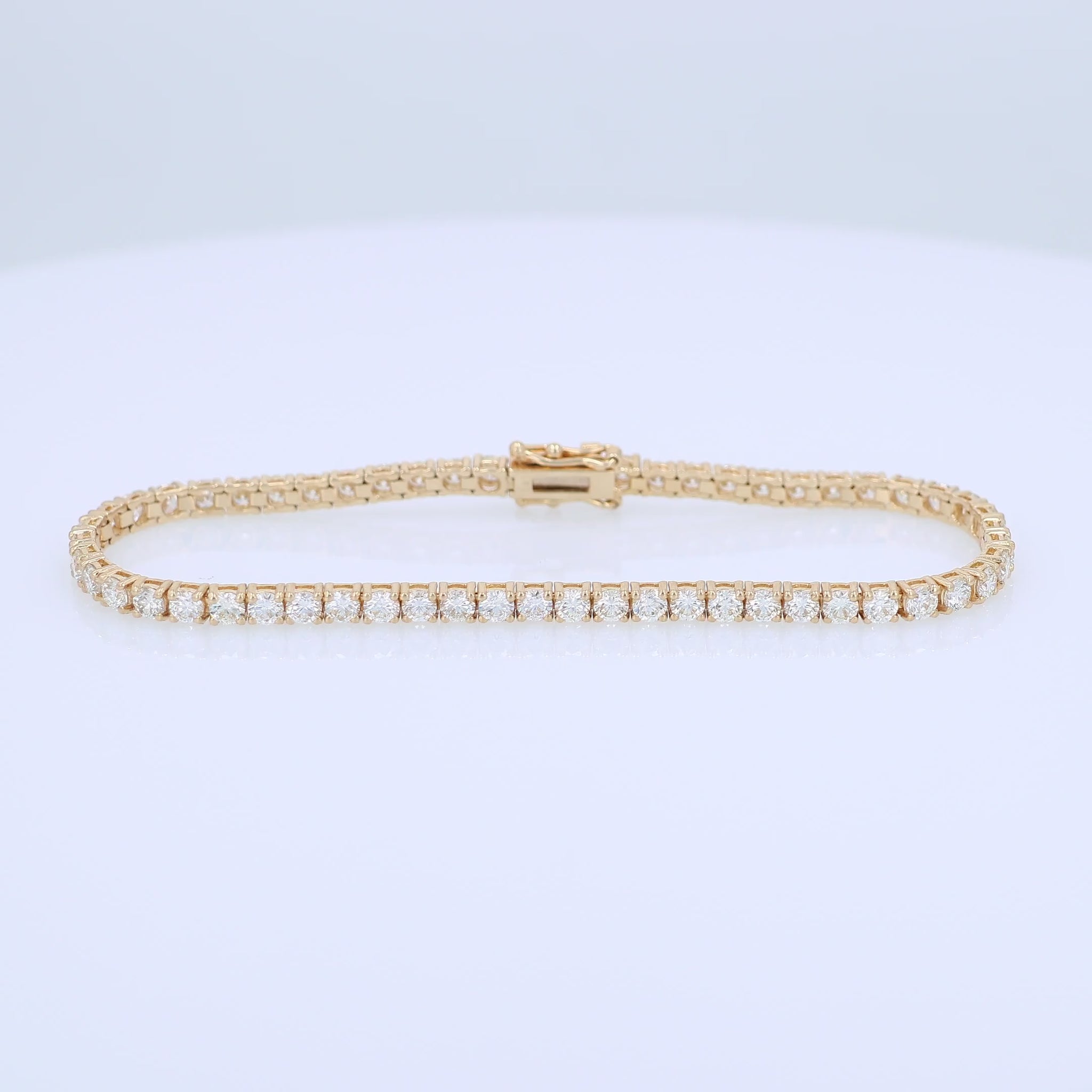 Yellow gold 5.03 carat diamond tennis bracelet on a white background