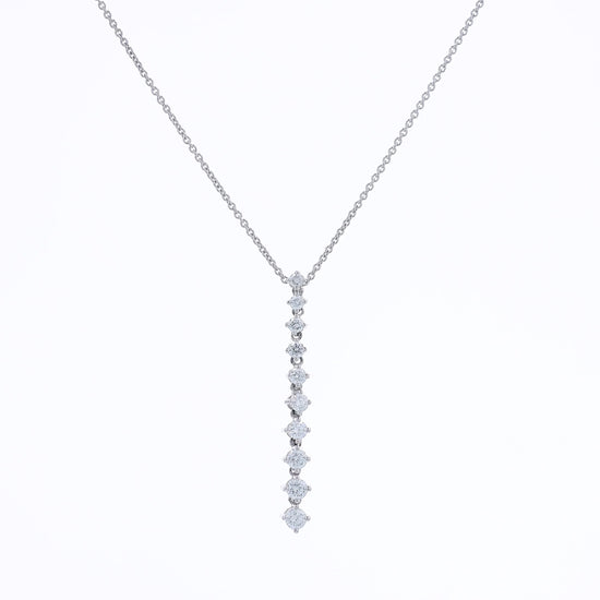 White gold single row graduated diamond pendant necklace on a white background