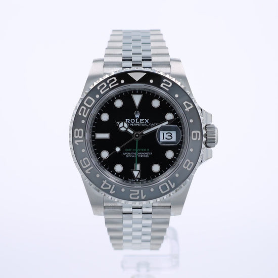 360 degree video of a Rolex watch with a black dial and grey and black bezel on a white background