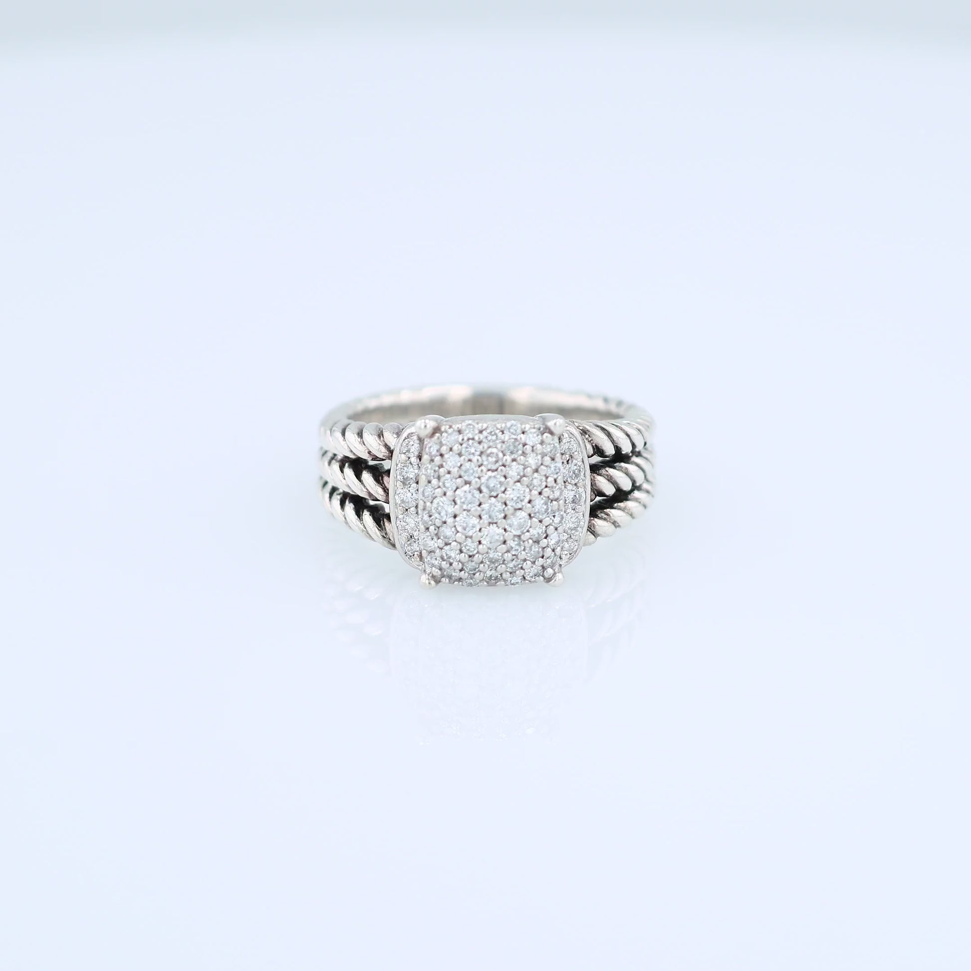David Yurman silver split shank cable design ring with a pave diamond cushion center on a white background