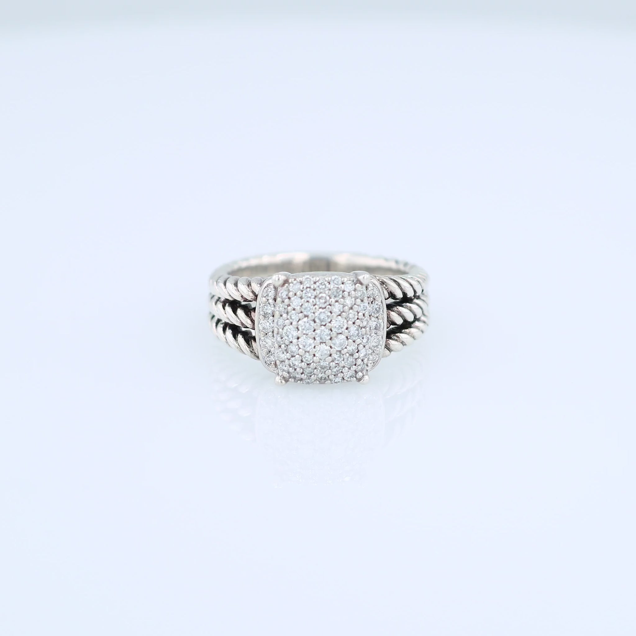 David Yurman silver split shank cable design ring with a pave diamond cushion center on a white background