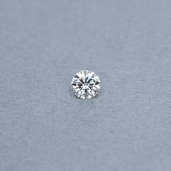 Round 1.51 carat GIA certified diamond graded LVVS1 on a grey background