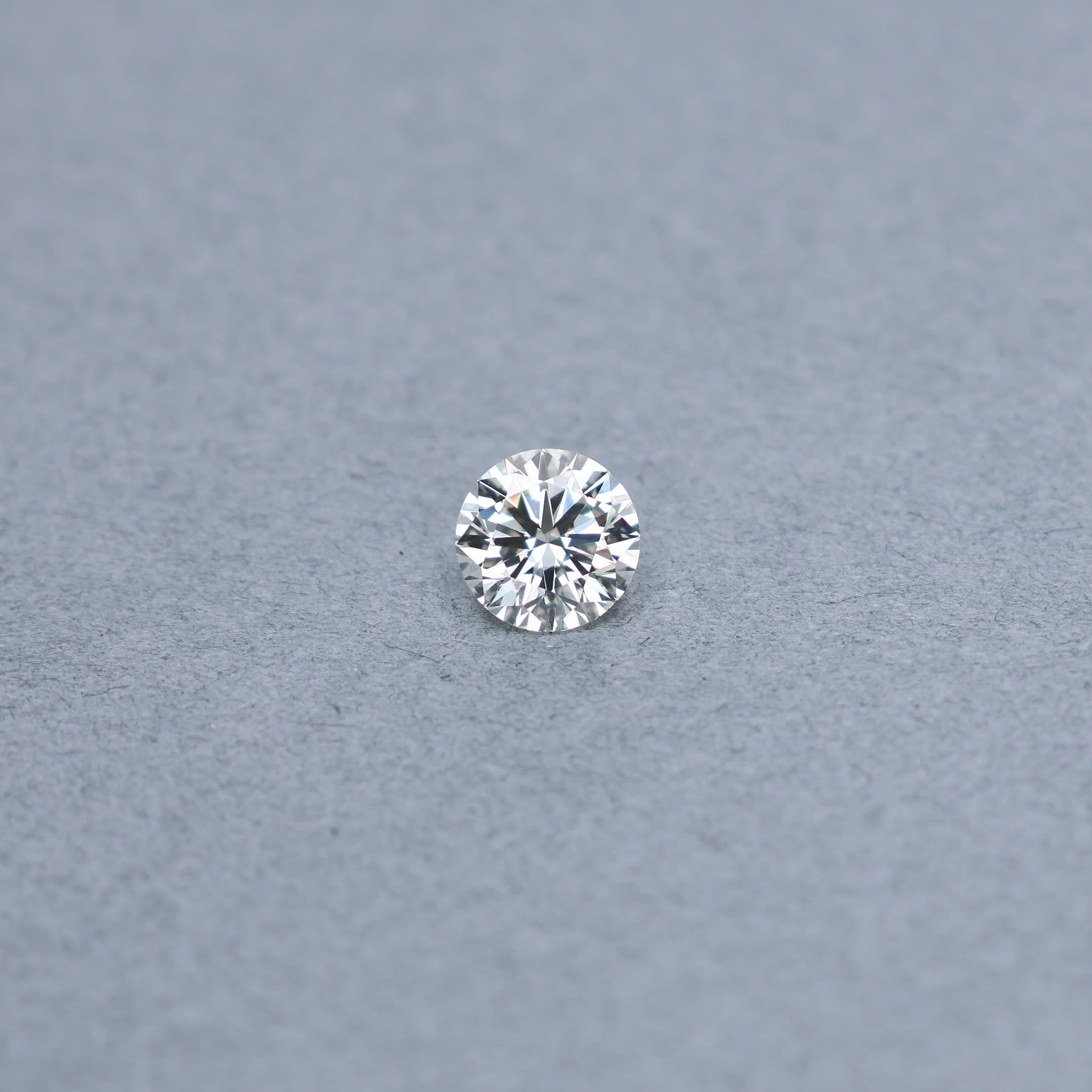 Round 1.51 carat GIA certified diamond graded LVVS1 on a grey background