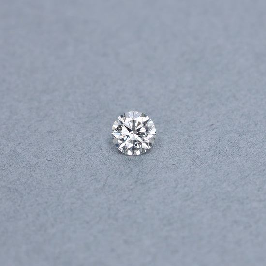 Round 1.54 carat GIA certified triple excellent diamond graded JSI1 on a grey background