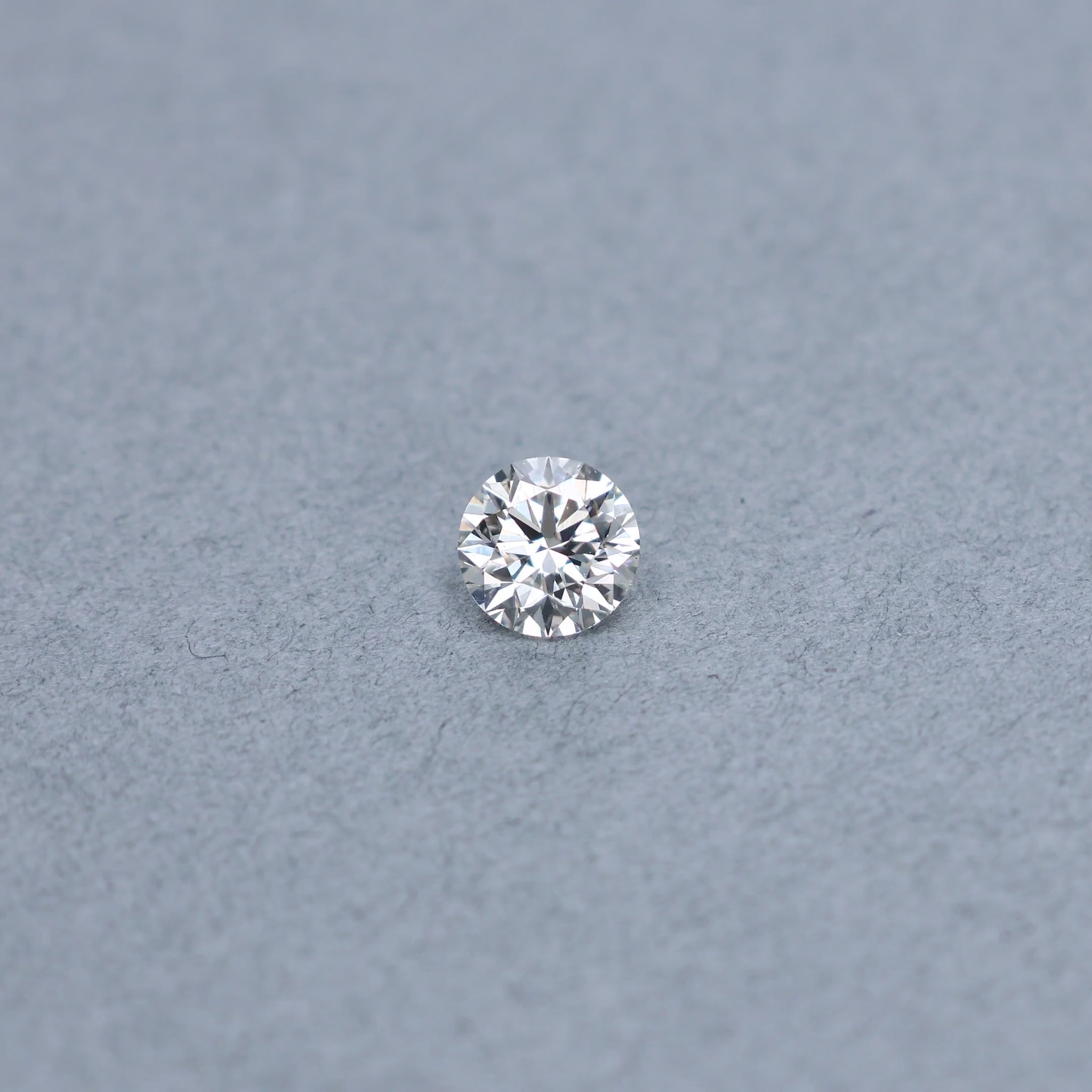 Round 1.54 carat GIA certified triple excellent diamond graded JSI1 on a grey background
