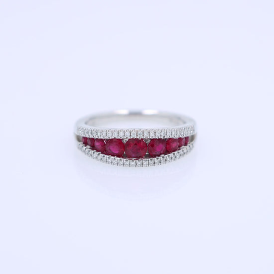 White gold ring with rubies and diamonds on a white background